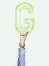 Hand holding balloon letter G Royalty Free Stock Photo