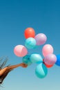 Hand holding balloons sky background Royalty Free Stock Photo