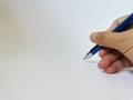 Hand holding ballpoint pen with copy space. Selective focus. Royalty Free Stock Photo