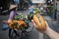 Hand holding Banh Mi sandwich on street in Hanoi Royalty Free Stock Photo