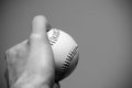 Hand holding a baseball close up