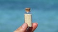 Hand holding beach sand in glass bottle. Mana island, Fiji Royalty Free Stock Photo