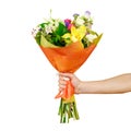 Hand holding a beautiful bouquet of different flowers. Isolated Royalty Free Stock Photo