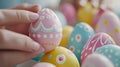 A hand holding a beautifully painted Easter egg among a collection of colorful, decorated eggs Royalty Free Stock Photo
