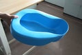 Hand holding bedpan Royalty Free Stock Photo