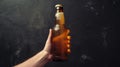 Hand holding beer bottle against dark backdrop, Ai Generated Royalty Free Stock Photo