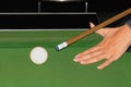 Hand holding billiards cue and aiming at the ball Royalty Free Stock Photo