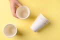 Hand holding biodegrable coffee cup on yellow background Royalty Free Stock Photo