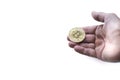 A hand holding a bit coin, as in a position to receive or accept a cryptocurrency as a payment form, white background, selective Royalty Free Stock Photo