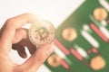 Hand holding bitcoin with background Candlestick chart make from color paper white and red