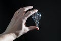 Hand holding a black bulb isolated Royalty Free Stock Photo