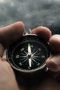 Hand holding black compass Royalty Free Stock Photo