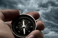 Hand holding black compass Royalty Free Stock Photo