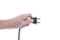 Hand holding Black electrical plug a removable cord from a power outlet on a white background. Save energy Concept Royalty Free Stock Photo