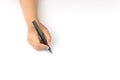 Hand holding black fountain pen writing on white paper Royalty Free Stock Photo