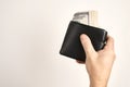 Hand holding black leather wallet with money, csloe-up Royalty Free Stock Photo