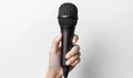 Hand Holding a Black Microphone Royalty Free Stock Photo