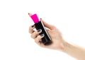 Hand holding a black and pink bottle of eau de toilette. Close up. Isolated on a white background Royalty Free Stock Photo