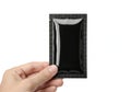 Hand holding a black rectangular object with reflective surface Royalty Free Stock Photo