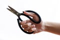 hand holding black scissor on isolated white background Royalty Free Stock Photo