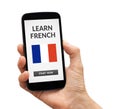 Hand holding smart phone with learn French concept on screen Royalty Free Stock Photo