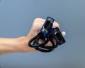 female hand holding VGA cable on gray background isolated Royalty Free Stock Photo