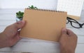 Hand holding blank brown notepad with space customizable for text or ideas. Copy space for ideas Royalty Free Stock Photo