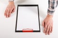 Hand holding blank clip board with white paper design mockup. Royalty Free Stock Photo