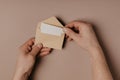 Hand holding blank envelope and letter mockup Royalty Free Stock Photo
