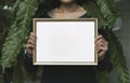 Hand Holding Blank Photo Frame for Design Mockup Template in the garden Royalty Free Stock Photo