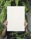 Hand Holding Blank Photo Frame for Design Mockup Template in the garden Royalty Free Stock Photo