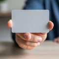 A hand holding a blank, rectangular card in a close-up shot. The card is smooth and white, with Royalty Free Stock Photo