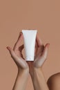 Hand-Holding Blank Skincare Tube on Minimalist Background