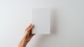 A hand holding a blank white card against a plain background, highlighting simplicity and minimalism. Royalty Free Stock Photo
