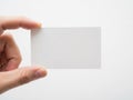A hand holding a blank white card against a plain background Royalty Free Stock Photo