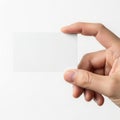 A hand holding a blank white card or small rectangular object against a plain background Royalty Free Stock Photo