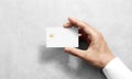 Hand holding blank white credit card mockup with rounded corners Royalty Free Stock Photo