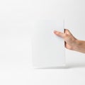 A hand holding a blank white rectangular object against a white background isolated on white background Royalty Free Stock Photo