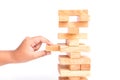 Hand holding blocks wood game (jenga) isolated on white background. Risk concept Royalty Free Stock Photo