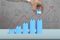 Hand holding blue block complete growth bar graph shape Royalty Free Stock Photo