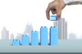 Hand holding blue block complete growth bar graph shape Royalty Free Stock Photo