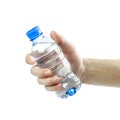 Hand holding a blue bottle of drinking water. Close up. Isolated on white background Royalty Free Stock Photo