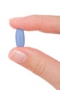 Hand holding a blue pill Royalty Free Stock Photo