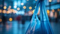 Hand holding blue plastic bag in blurred night city lights Royalty Free Stock Photo