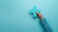 A Hand Holding Blue Plus Sign.AI generated image Royalty Free Stock Photo