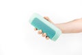 Hand holding blue wireless speaker