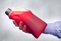 Hand Holding a Bottle of Antifreeze Royalty Free Stock Photo