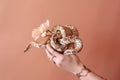 Hand holding a bouquet of snakes created with Generative AI technology