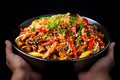 Hand holding bowl of chinese food on black background, colorful close up cuisine, generative AI