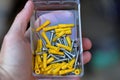 Hand holding box of screws and plastic anchors